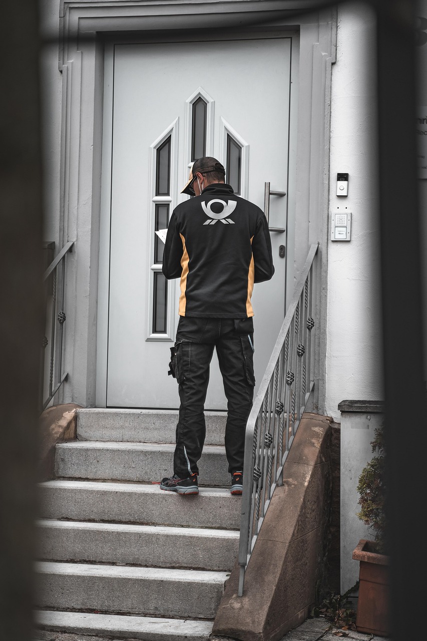 Delivery courier handing package at a Korean residential door