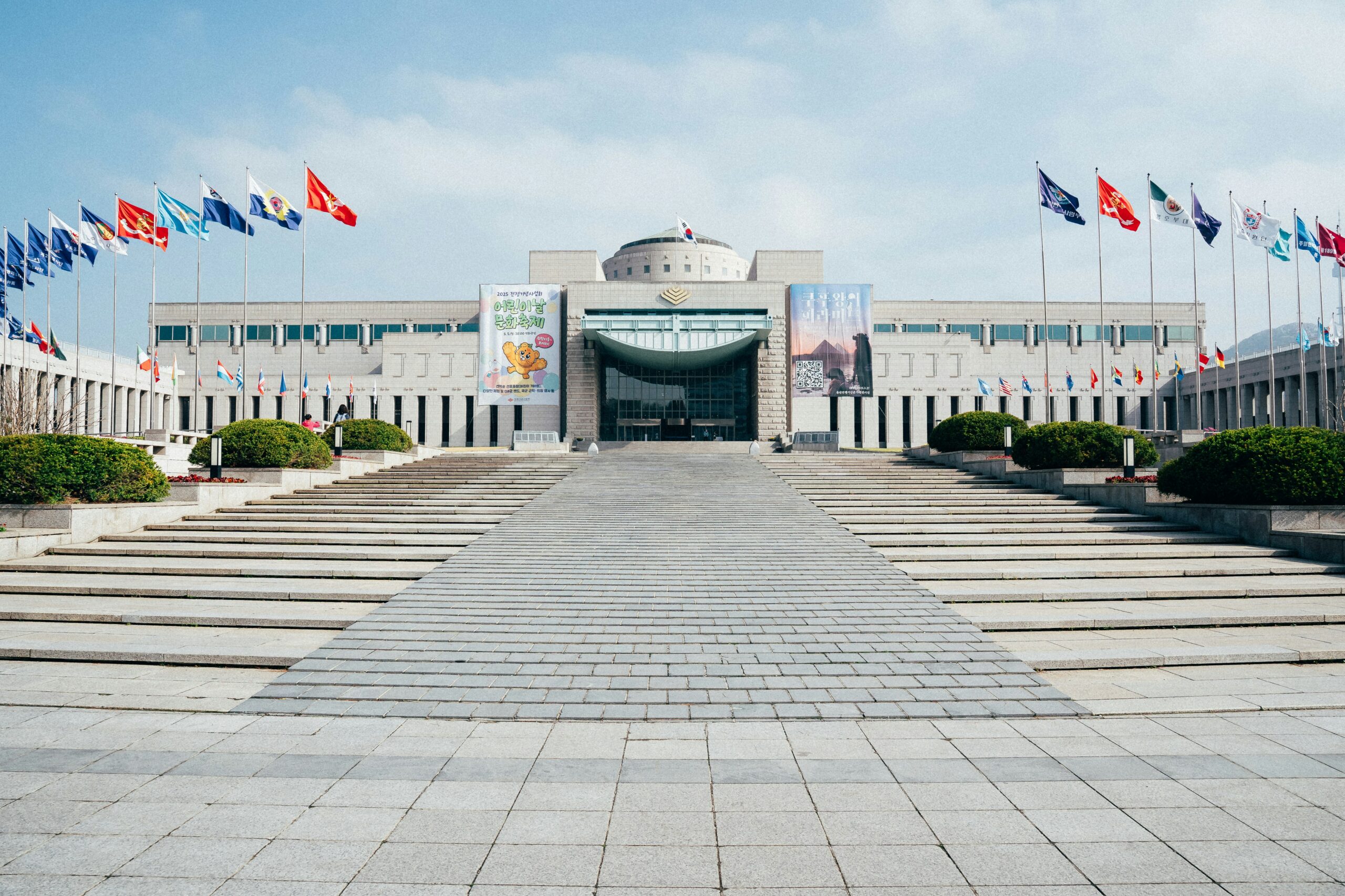 Korean government complex building entrance with flags