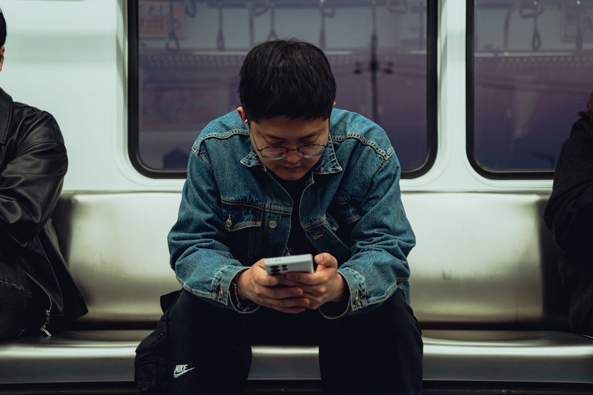 Young man using smartphone for SKT KT LGU+ address update in Korea