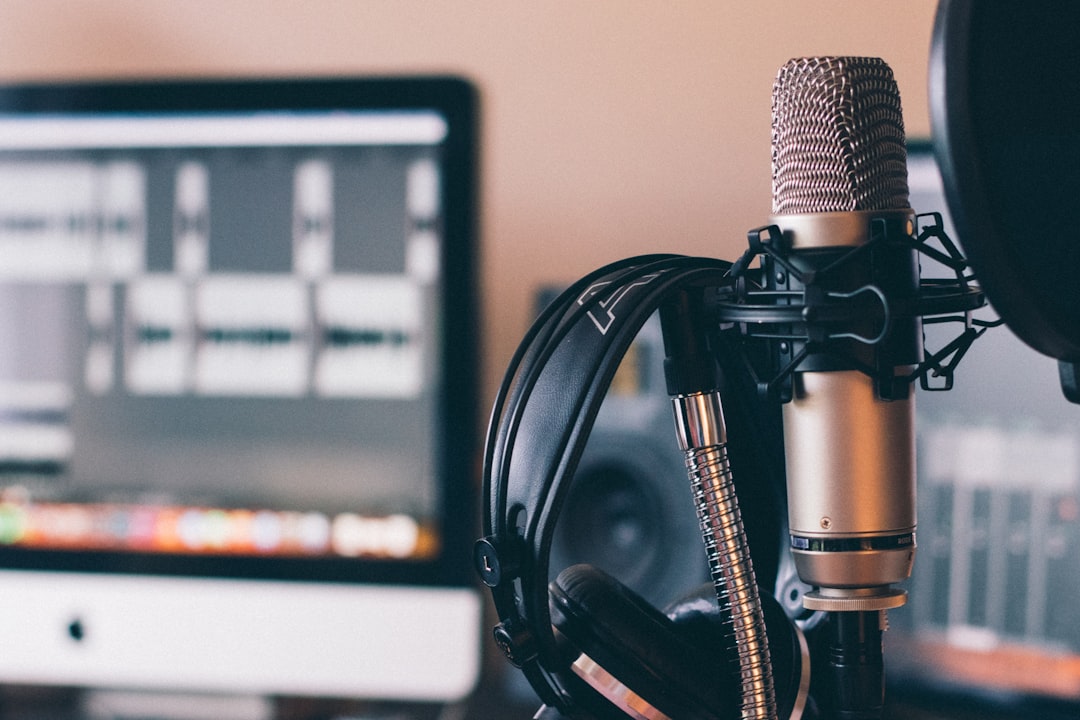 AI voice production workflow with recording microphone and laptop