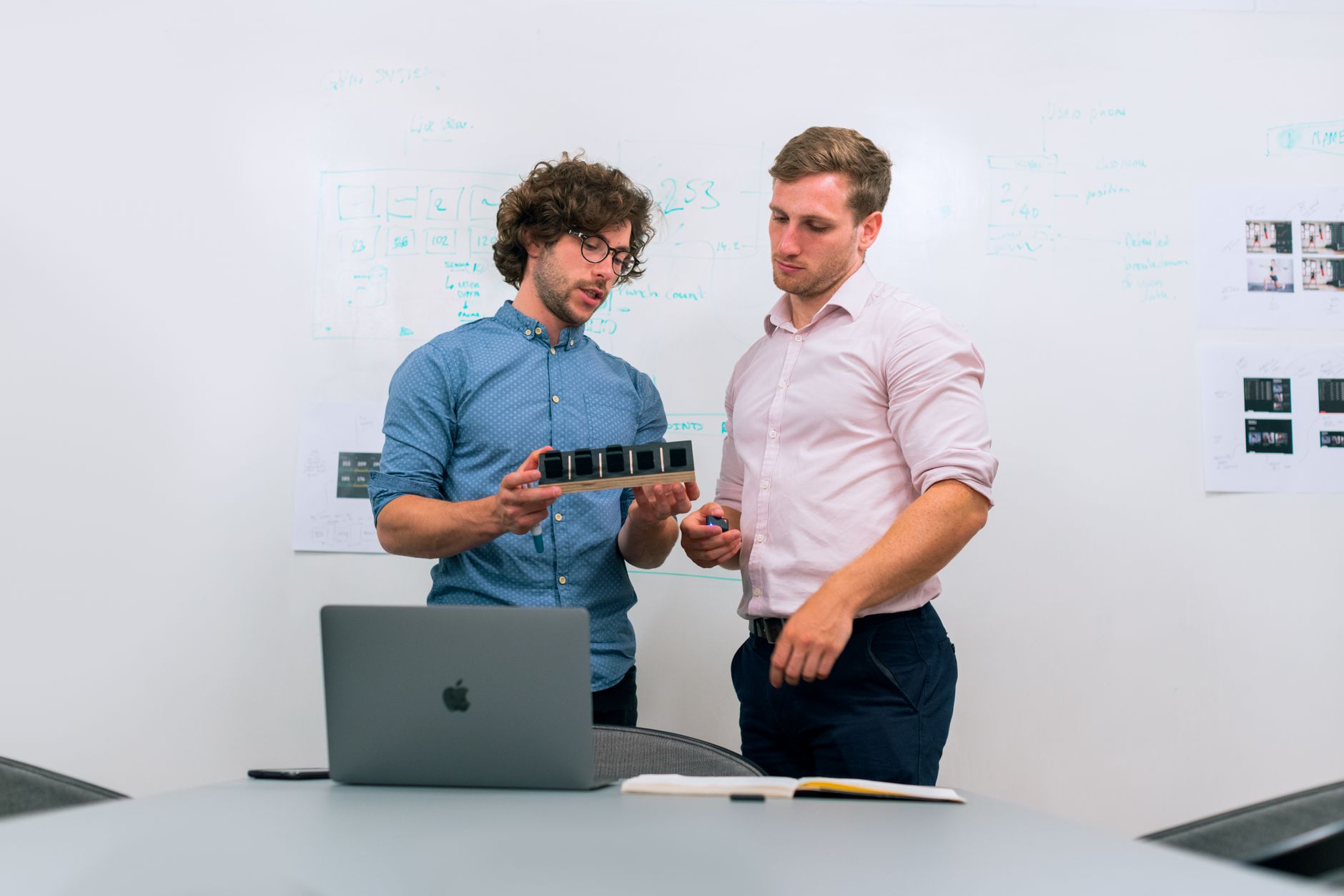 Product designer and developer reviewing an AI design handoff workflow from approved concept to build