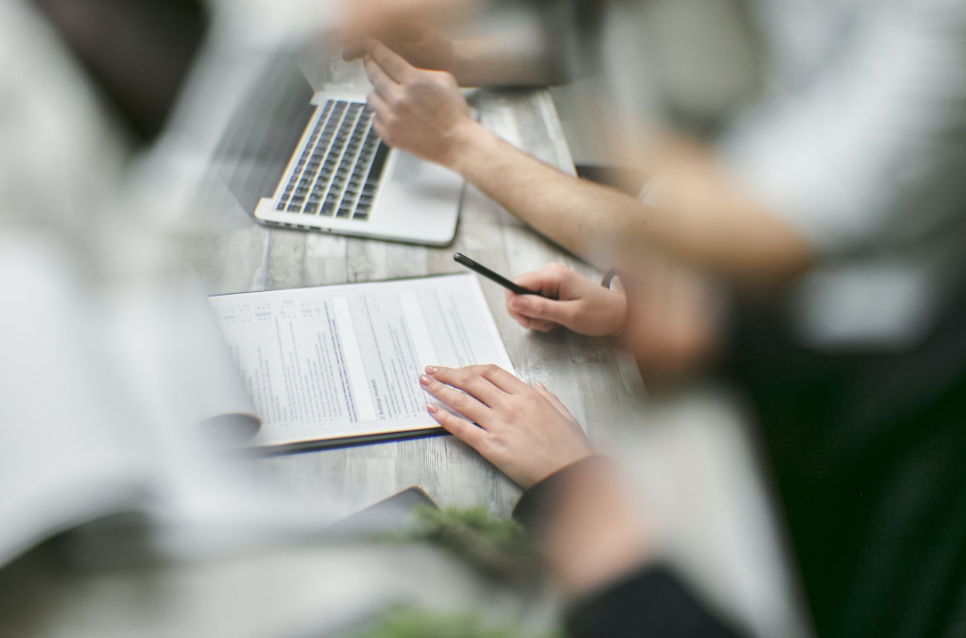 Colleagues checking decision history permissions and review triggers before a handoff